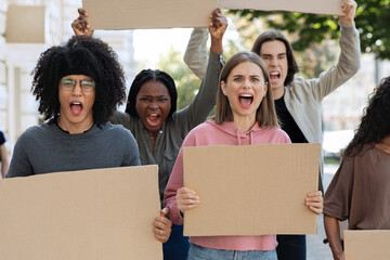 Furious mutiracial group of demonstrators protesting on the street, closeup