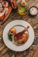 Portion of roast duck leg with apple