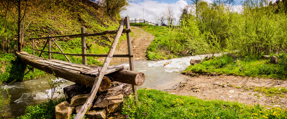 a wooden footbridge through the fast river in the Carpathian national park Skolivski beskidy, Lviv region of Western Ukraine