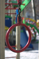 Fototapeta na wymiar red metal ring on a chain on the sports field