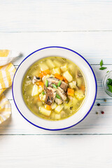 Fish stew in a bowl on wooden background. Space for text, top view.