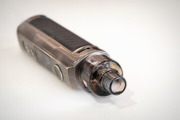 Close up of electronic cigarettes on a white background with smoke on a blurred background