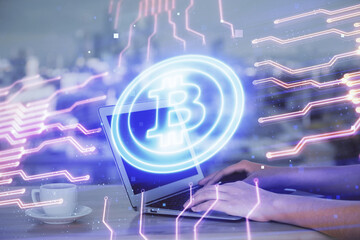 Double exposure of woman hands typing on computer and crypto market theme hologram drawing....