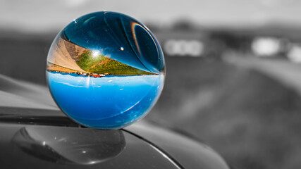 Crystal ball landscape shot with black and white background outside the sphere near Strasskirchen, Bavaria, Germany