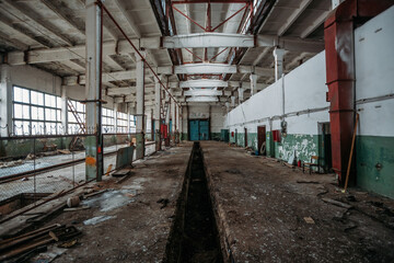 Naklejka na ściany i meble Old broken empty abandoned industrial building interior