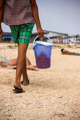 close-up a beach vendor with bucket of shrimps, Arabat spit, Azov sea, Ukraine