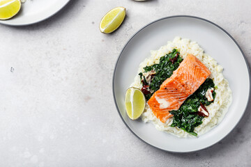 Salmon fillet with rice and spinach garnish