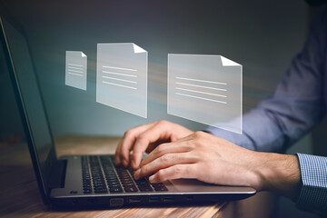 man working computer with file icons