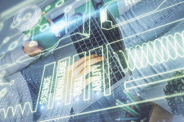 Double exposure of woman hands typing on computer and general theme hologram drawing. Education concept.