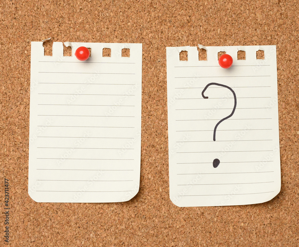 Poster white sheet of paper with a question mark attached with red buttons to a brown cork board