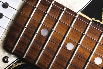 Close-up elements of electric guitar on gray background