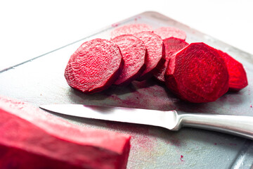Slices of juicy beetroots on chopping board for cooking