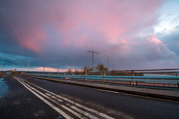 Fototapeta na wymiar Stormy sunset over the road bridge