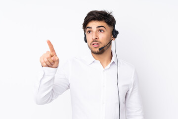 Telemarketer Arabian man working with a headset isolated on white background touching on transparent screen