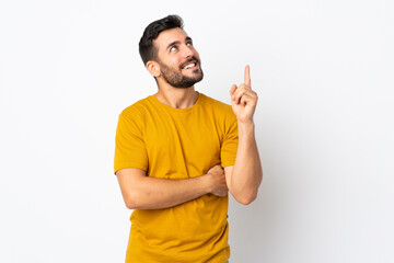 Fototapeta premium Young handsome man with beard isolated on white background pointing up a great idea