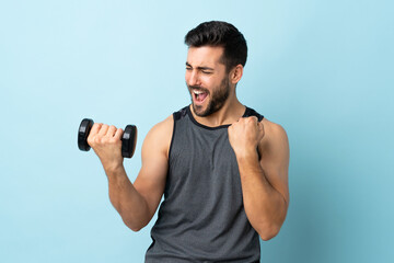Fototapeta na wymiar Young sport man with beard making weightlifting celebrating a victory
