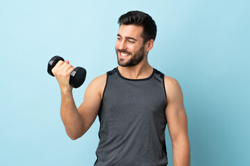 Young sport man with beard making weightlifting with happy expression