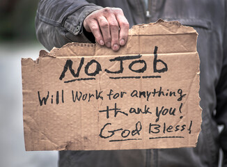 Man holding handwritten cardboard sign, No Job, Will Work, jobless, unemployed, coronavirus,...