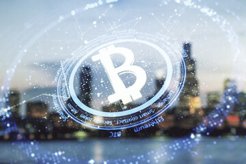 Double exposure of creative Bitcoin symbol hologram on blurry office buildings background. Mining...