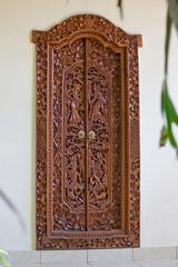 traditional Bali wood and stone decorative door with asian patterns