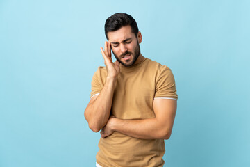 Fototapeta premium Young handsome man with beard over isolated background with headache