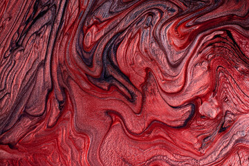Textured stains of liquid nail polish,fluid art technique.Red color.Shimmer marble background.Stripy paint texture.Nail lacquer flow modern backdrop. Minimalism concept.Copy space,horizontal photo.