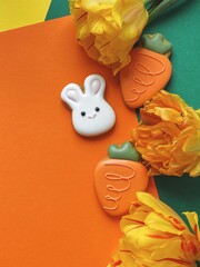 Cute white Easter bunny cookie with orange tulips 