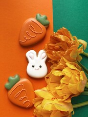 Cute white Easter bunny cookie with orange tulips 