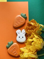 Cute white Easter bunny cookie with orange tulips 