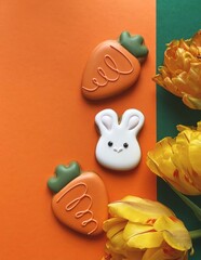 Cute white Easter bunny cookie with orange tulips 