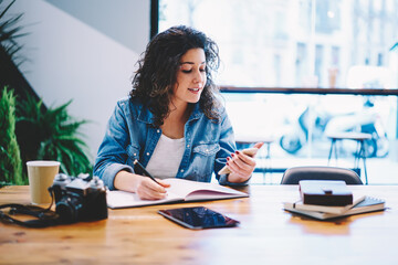 Caucaisan blogger reading content text in social media using mobile application in coworking space,...