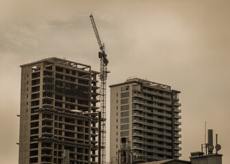 Fototapeta premium Skyscrapers construction with a crane in the middle