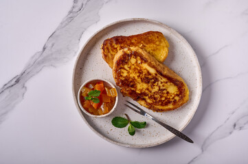 Homemade traditional Spanish torrijas or French toast with melon candied fruit and mint. Popular dessert for Christmas, Easter or Pascua. Top view