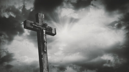 Jesus Christ crucified at Golgotha hill outside ancient Jerusalem. The crucifixion of Christ with stormy clouds in the sky. Vintage film look