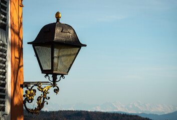Fototapeta na wymiar Ancient Lantern with the Swiss Alps in the Background