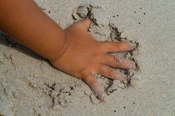 hands on sand. boy's hand on beach while playing in the send