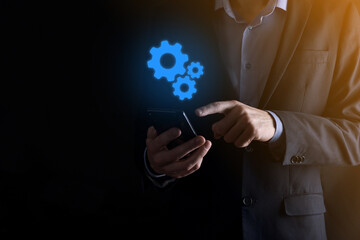 Business man in suit holding metal gears and cogwheels mechanism representing interaction teamwork concept,hand hold group of virtual cog gears wheel