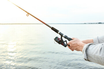 Man fishing on river bank