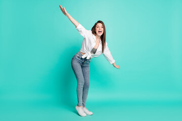 Fototapeta na wymiar Full length photo of attractive happy nice young woman make hands fly plane wings isolated on teal color backgroud