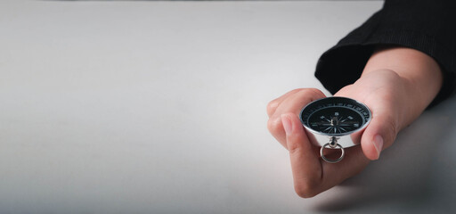 Business navigate concept, Businessman holding compass navigation for guide to recovery business planning growth in the economic crisis.