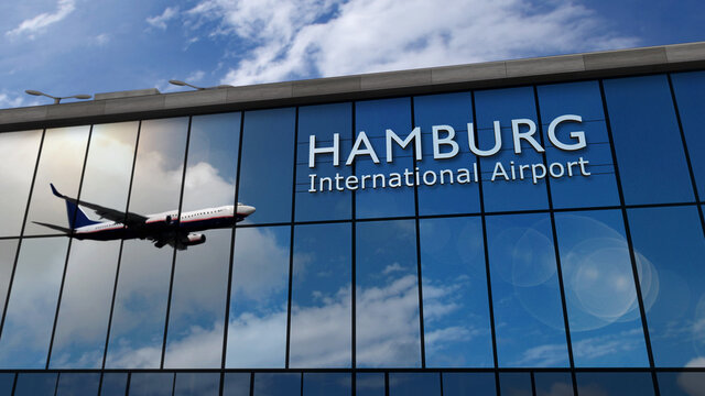 Airplane landing at Hamburg Germany airport mirrored in terminal