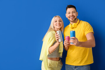 Couple with soda on color background