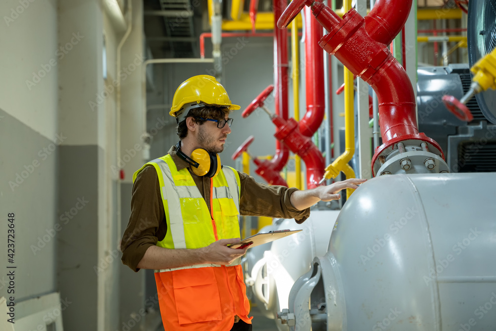 Aufkleber Technician engineer checking controls system for security functions in service room at factory,Heating,Ventilation,Air Conditioning.