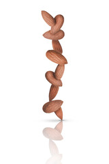 Many almonds  vertically balancing  in equilibrium isolated on a white background with reflection. Creative Composition  Food.