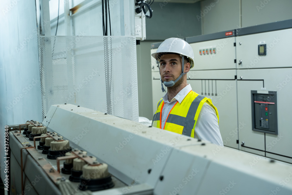 Poster control room engineer,power plant control panel,portrait of electrician engineer use tablet computer