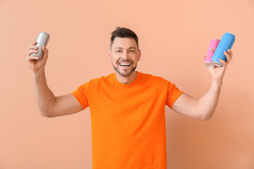 Handsome man with soda on color background