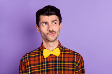 Photo of attractive thoughtful young guy wear plaid shirt looking empty space isolated violet color background