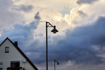 Fototapeta na wymiar Street light with a dramatic cloud scenario.