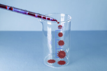 Medical laboratory. The virus-infected blood from the pipette is poured into an empty test tube on...