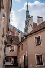 Narrow streets of the Riga Old Town with St. Peter's Church in the background